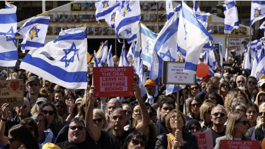 Mourners paid their respects to the Bibas family at Hostages Square in Tel Aviv - some holding up signs urging the Israeli government to ensure the return of all remaining hostages